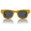 Yellow square sunglasses with dark lenses shown against a white background and reflected on a surface.