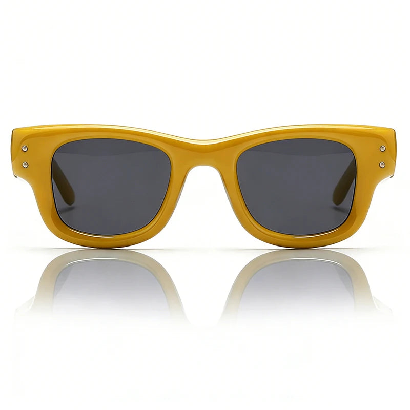 Yellow square sunglasses with dark lenses shown against a white background and reflected on a surface.