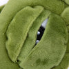 Close-up of a soft green fabric sleep mask with a cutout showing a black and white interior.