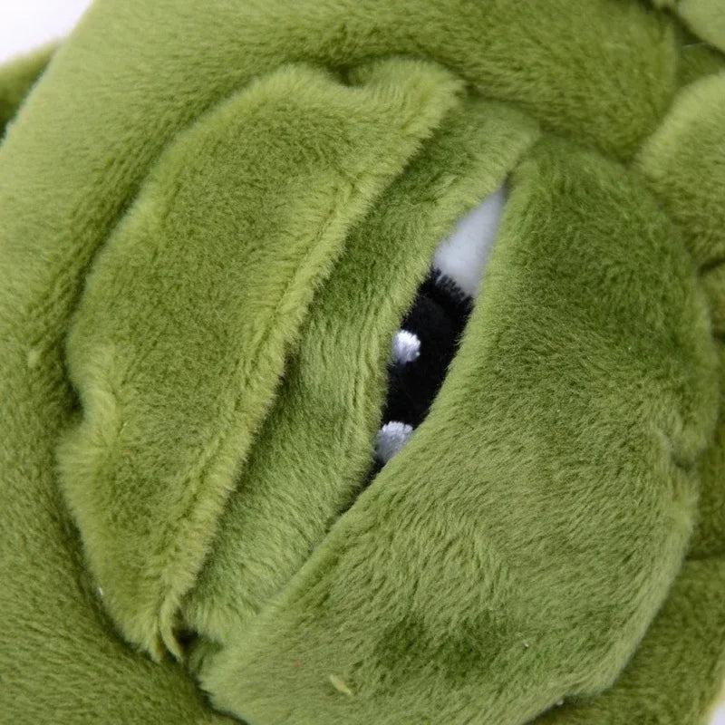 Close-up of a soft green fabric sleep mask with a cutout showing a black and white interior.