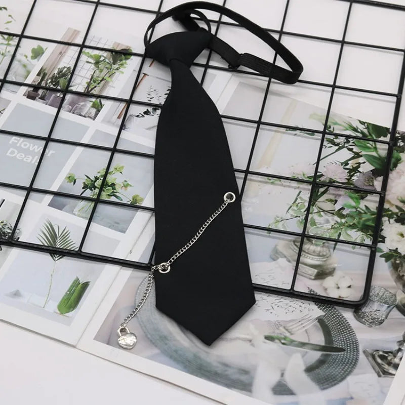 A black classic chain necktie accessory is displayed against a grid background of floral and natural imagery.