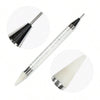 A set of four rhinestone nail art decorations, including a pointed applicator and a light-colored nail tip.