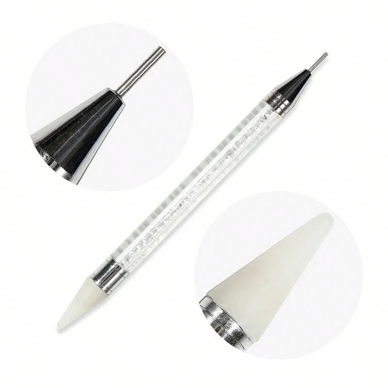 A set of four rhinestone nail art decorations, including a pointed applicator and a light-colored nail tip.