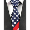 A navy blue and white stars American flag silk necktie worn against a black suit jacket.