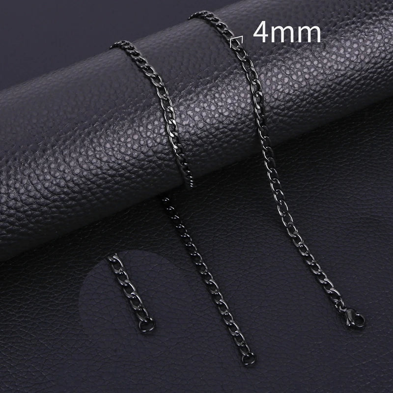A close-up of a black stainless steel Cuban link necklace with a 4mm chain, displayed on a dark leather surface.