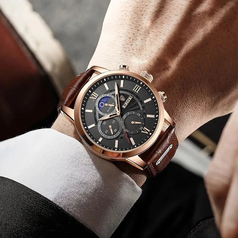 A close-up of a rose gold watch with a brown leather strap worn on a wrist.