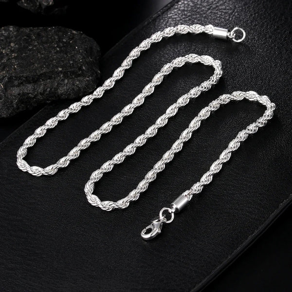 A set of twisted rope necklaces and bracelets made of 925 sterling silver displayed on a black surface.