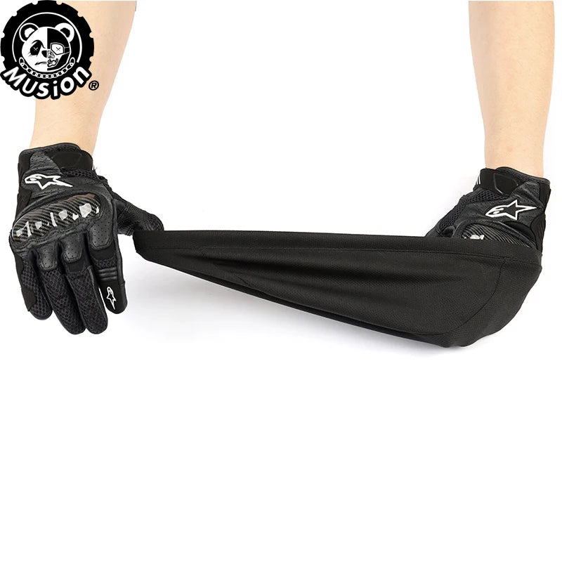 Black moisture-wicking cycling beanie cap being worn on a hand and arm.