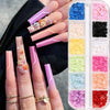 A hand displays long pink and white nail extensions adorned with small butterfly bow charms.