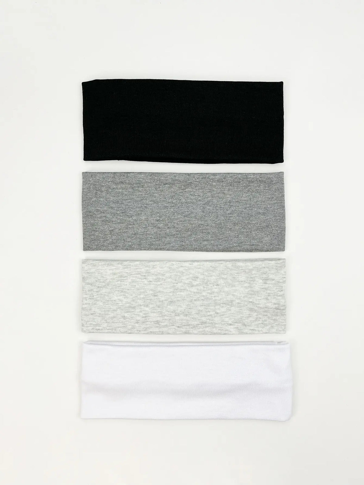 A set of four knitted hair bands in black, gray, light gray, and white.