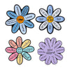 A set of enamel flower brooches featuring inspirational words like Happy Loved Strong and ingredients for success and kindnes
