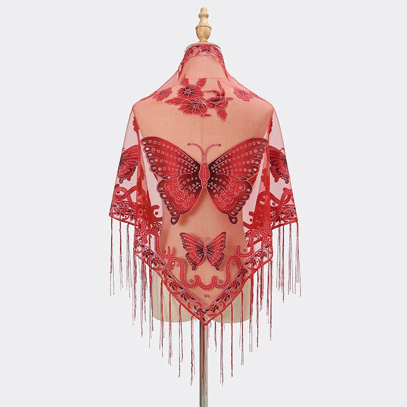 A sheer red butterfly lace scarf shawl displayed on a hanger with long fringe.