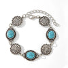 Silver beaded necklace and bracelet set featuring turquoise flower motifs