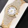 A gold-toned quartz wristwatch adorned with full pave rhinestones on the bezel and bracelet.