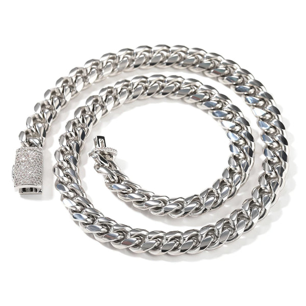 A silver stainless steel Cuban link necklace coiled on a white background.