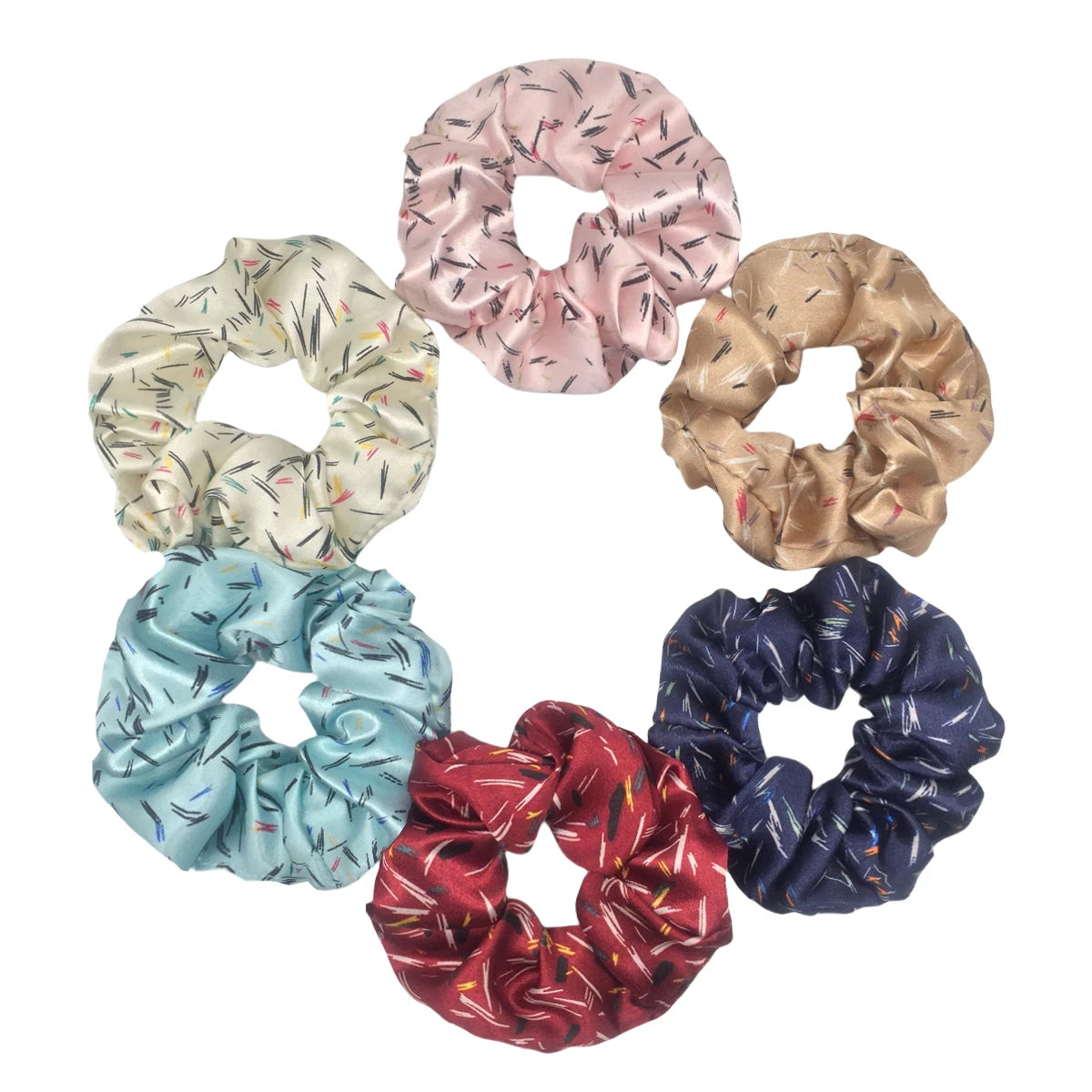 Un set de seis gomas de tela satinada con diferentes estampados y colores florales para el cabello