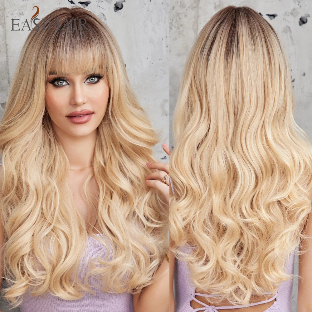 A woman models a long, wavy sandy blonde golden cosplay wig with long bangs.