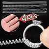 A set of four clear invisible ring size adjusters, including multiple sizes and a finished ring.
