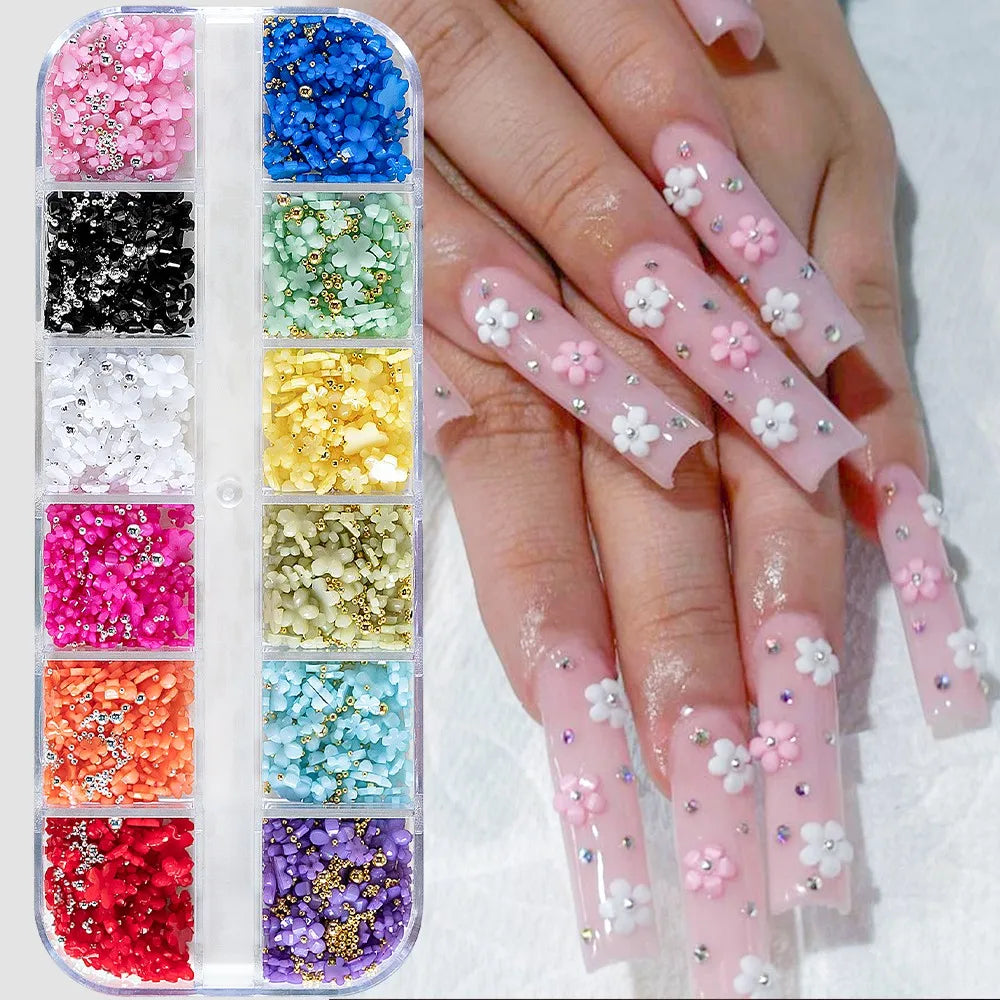 A hand displays various pink and white butterfly bow nail charms organized in a clear plastic case.