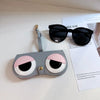A gray and pink faux leather pouch designed to store sunglasses or eyewear, with a strap attached.