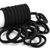 A stack of black elastic hair bands coiled together.