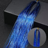 A long, vibrant blue glitter hair extension strand is displayed against a dark background.