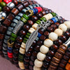 A close-up of colorful fashion elastic wood bead bracelets stacked together.