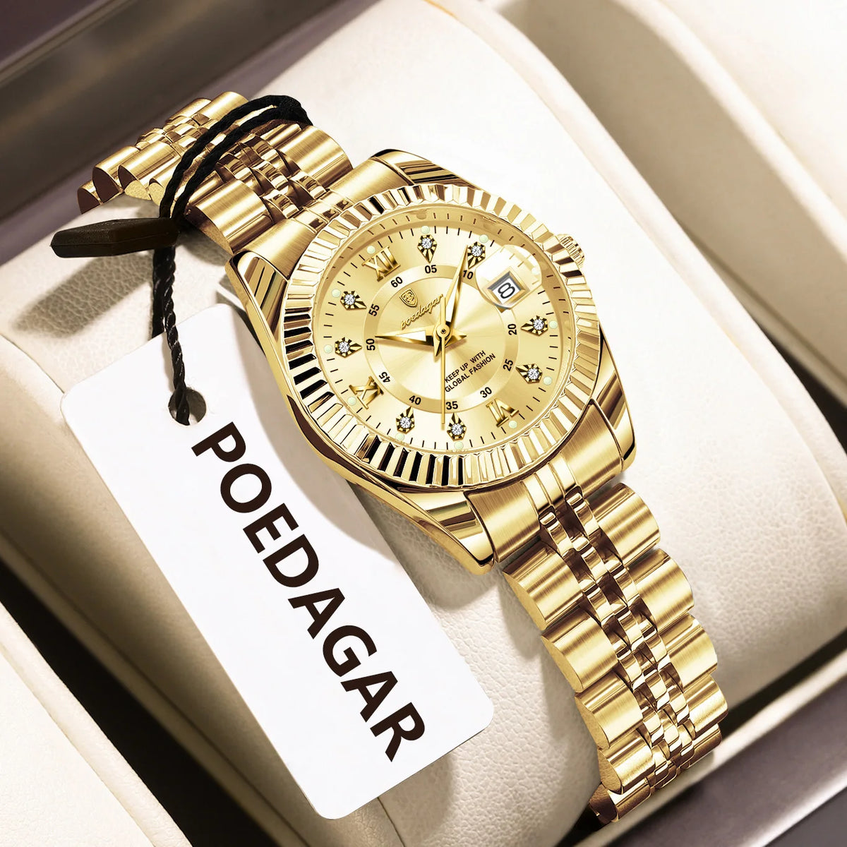 A gold-toned ladies wristwatch with a metal bracelet is displayed on a white card.