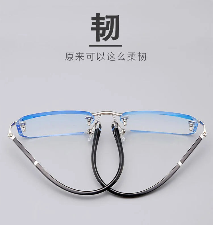 A pair of clear, frameless reading glasses with thin metal frames and blue tinted lenses displayed against a light gray backg