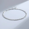 Bracelet-charm cœur argent sterling 925, exposé sur une surface gris clair.