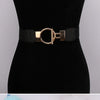 A black belt with a gold round buckle and black fabric strap displayed on a black mannequin.