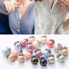 A collection of iridescent pearl buttons in various shades and sizes for clothing and decor.