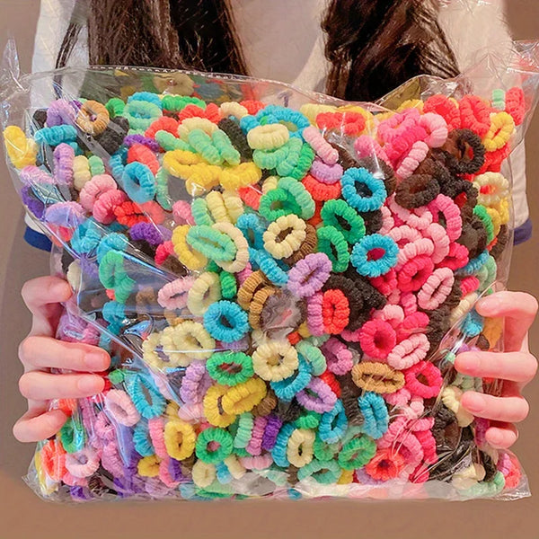 A colorful assortment of elastic hair bands for girls in various bright and pastel colors.