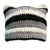 A striped crocheted beanie hat featuring alternating black, white, and gray yarn bands.