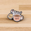 A vintage enamel pin brooch shaped like a teacup with steam and the words Tea time