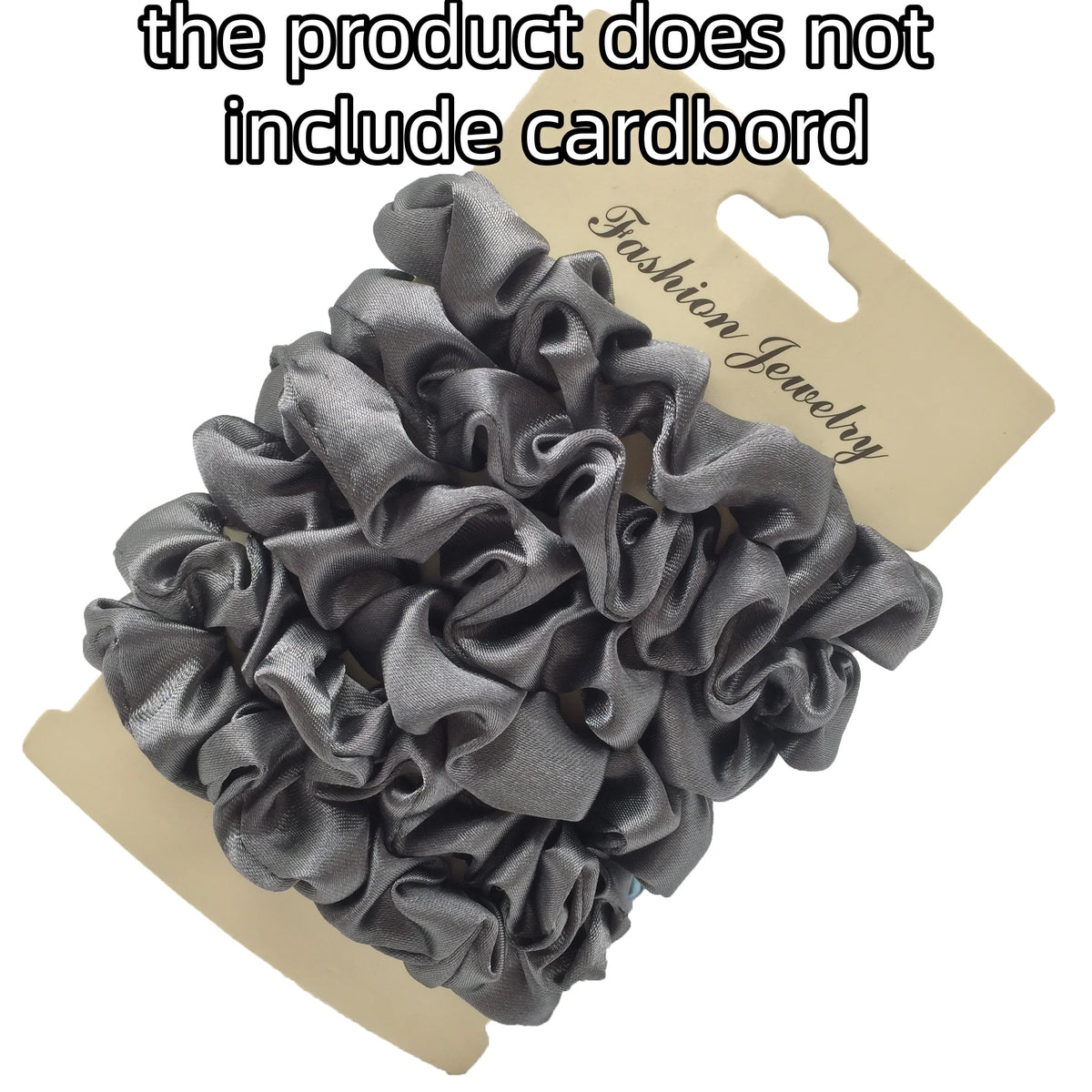 A pile of gray satin hair scrunchies is shown on a cardboard tag.