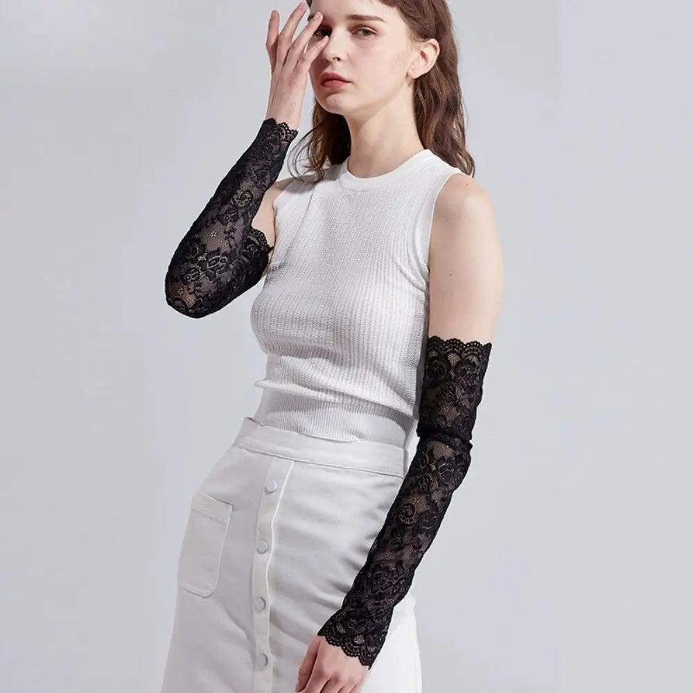 A woman models white clothing and black lace anti-sunburn arm sleeves.