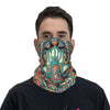 A man wearing a colorful bohemian hamsa hand bandana neck gaiter around his face.