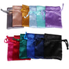 A collection of satin drawstring jewelry pouches in various colors including pink, orange, light blue, mint green, purple, an
