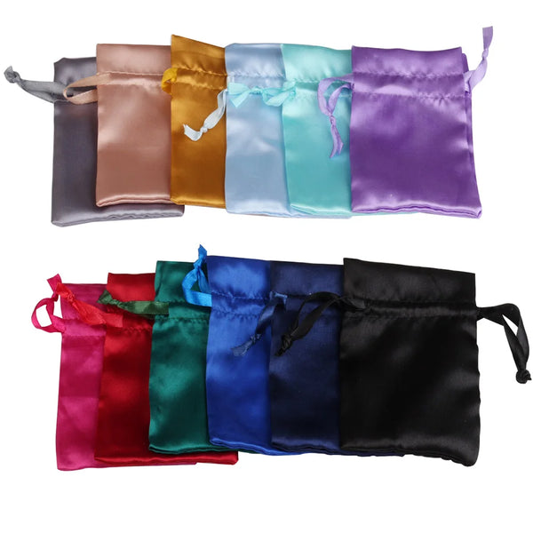 A collection of satin drawstring jewelry pouches in various colors including pink, orange, light blue, mint green, purple, an