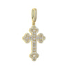 Pendentif de croix ton or incrusté de pierres claires.