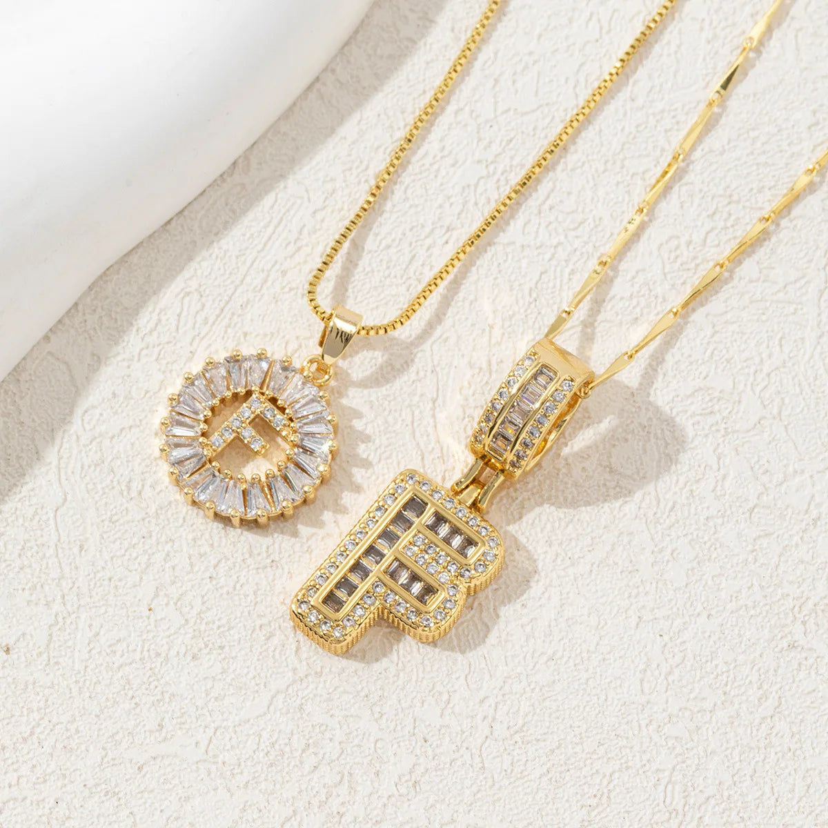 Gold initial letter necklace set featuring CZ crystal pendants for a couple
