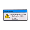 A vintage enamel pin featuring a system message with a yellow warning triangle and the text Please be patient with me I'm fro