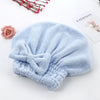 Light blue microfiber hair drying towel with a ruched texture placed on a white surface.