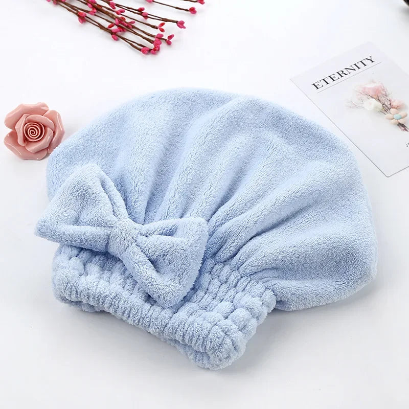 Light blue microfiber hair drying towel with a ruched texture placed on a white surface.