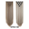 A pair of long, straight hair extensions in a light brown shade shown side by side.