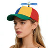 A woman wearing a funny multicolor propeller hat with blue, yellow, and red panels.