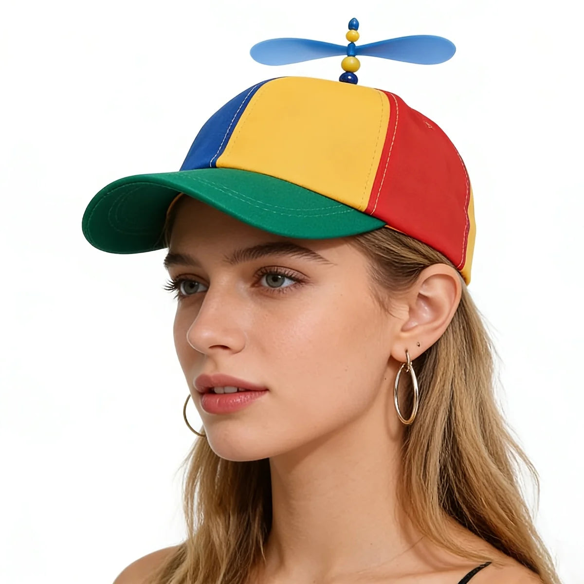 A woman wearing a funny multicolor propeller hat with blue, yellow, and red panels.