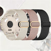 Three colored stretchy nylon watch bands for Garmin devices displayed on a white surface.