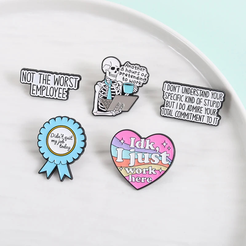 A collection of enamel pins featuring funny work quotes like Not The Worst Employee and Idk I just work here